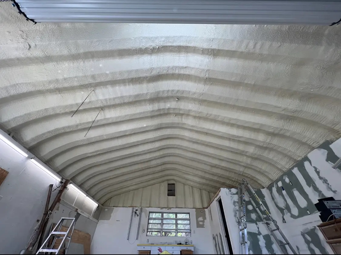 Spray polyurethane foam applied to the underside of a metal roof deck in Summerfield